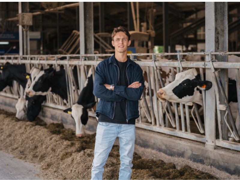 Agrarisch Ondernemerschap Dier en veehouderij, student met koeien op de achtergrond